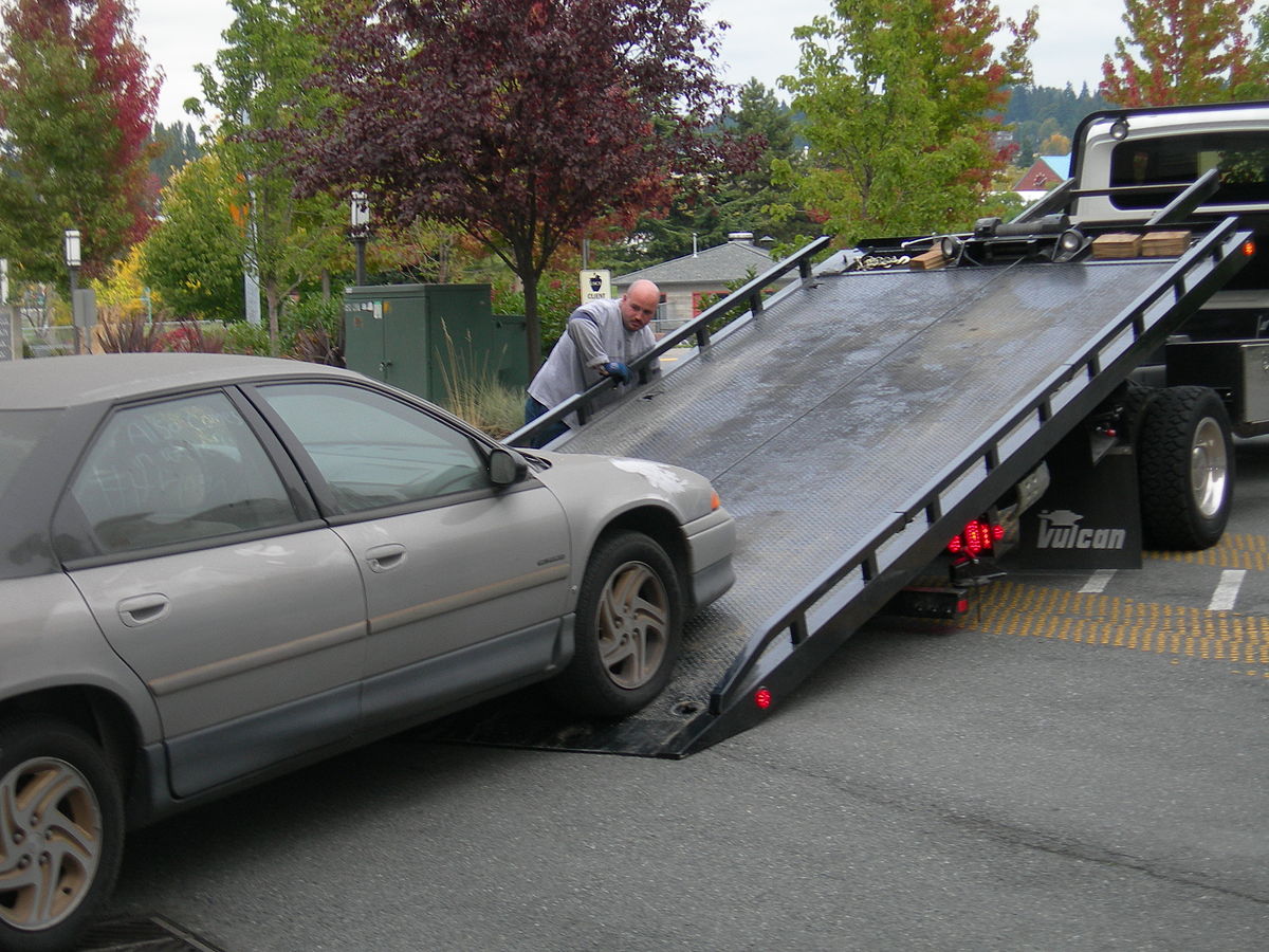 Tow Truck And Broken Car On Country Road