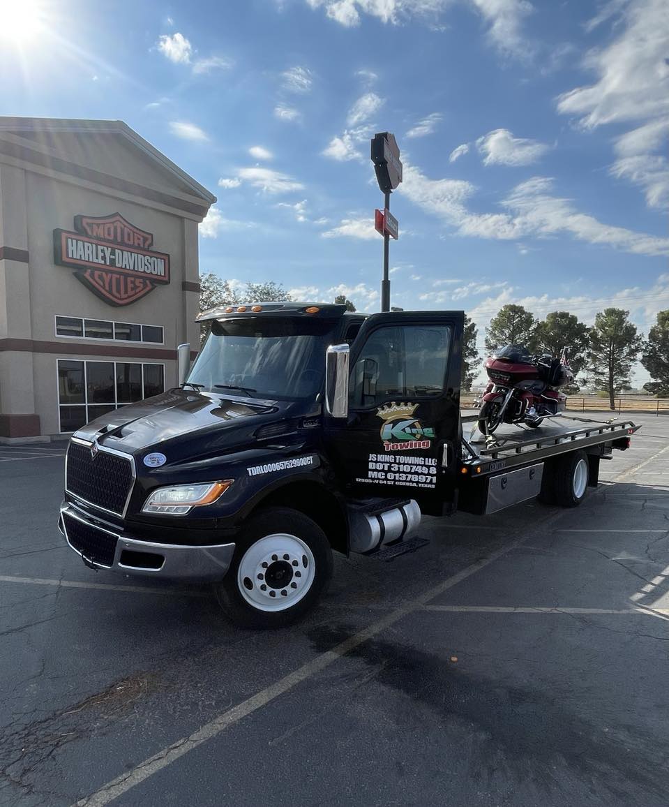 Portrait Of A Tow Truck Woker With A Towed Car